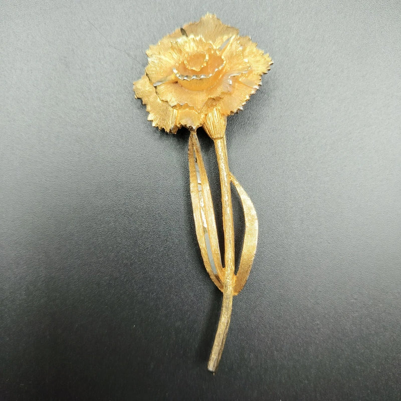 Brushed gold-tone 3D flower brooch with long stem and leaf details