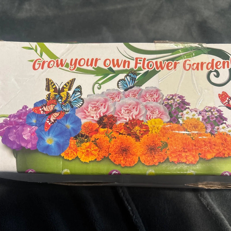 Flower garden kit box with colorful flower illustrations, butterflies and greenery