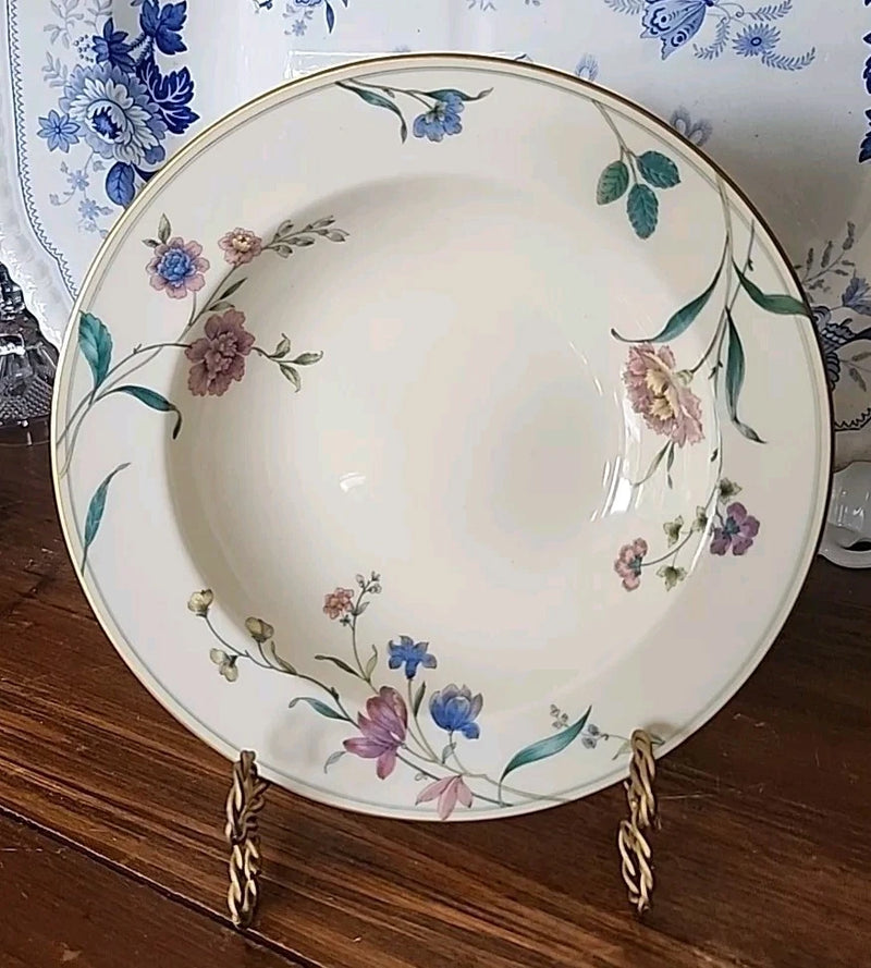 Ivory porcelain serving bowl with blue and pink floral pattern and green leaves