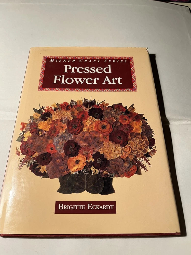 Pressed flower art book with dried floral cover illustration and title text, hardcover