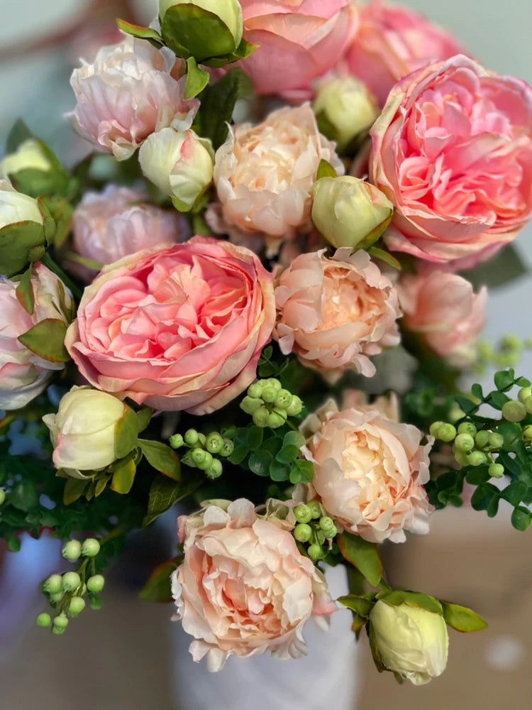 Rose stem arrangement with deep pink, peach, and cream open roses and buds