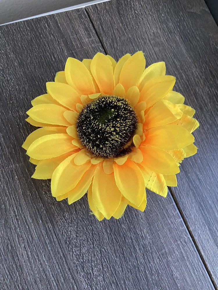 Artificial sunflower head decoration with bright yellow petals and dark textured center