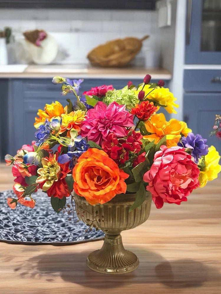 Colorful spring floral centerpiece in gold pedestal planter, peonies and roses
