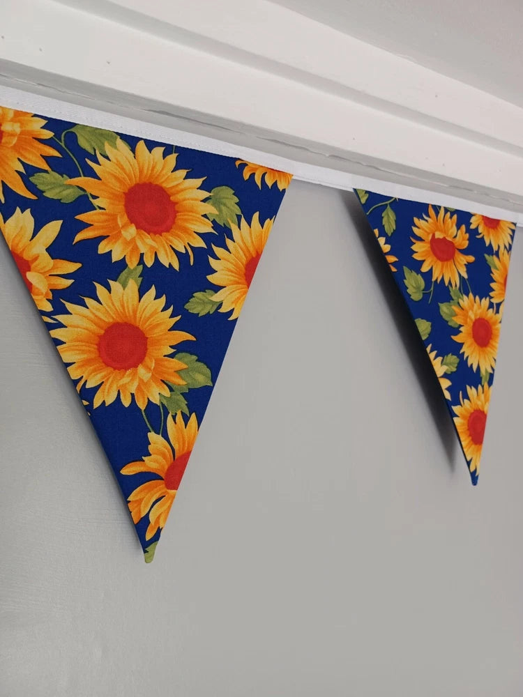 Fabric sunflower bunting with triangular pennants in blue with bright yellow flowers
