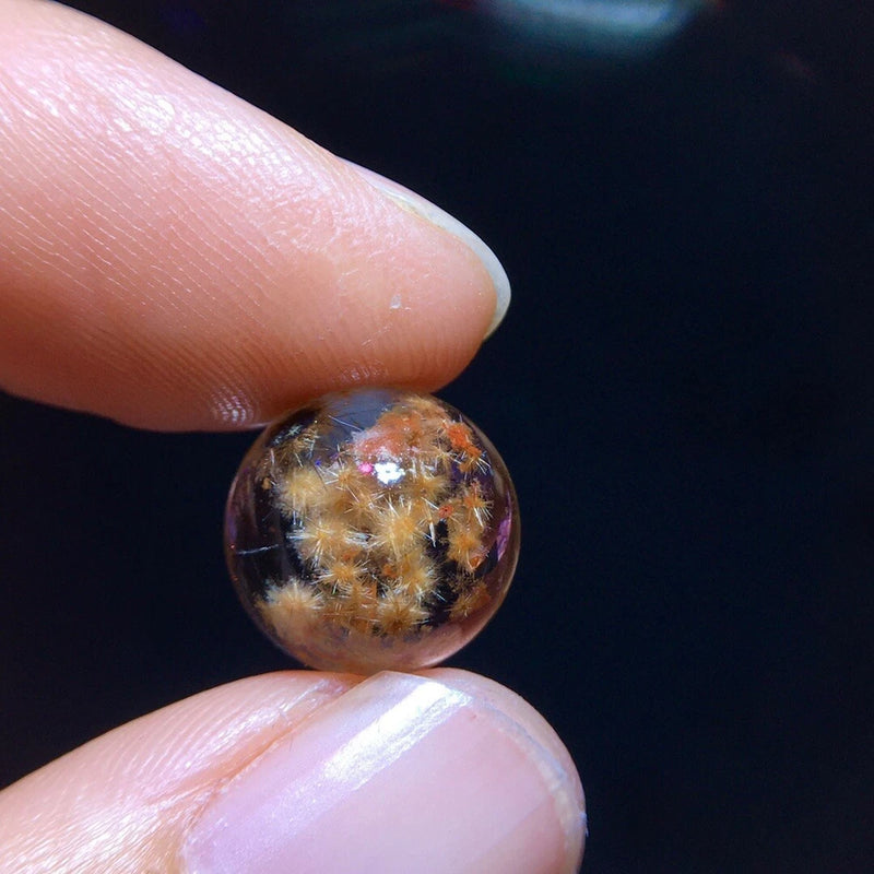 11.5mm round crystal bead with sunflower snowflake pattern, dark base and golden specks