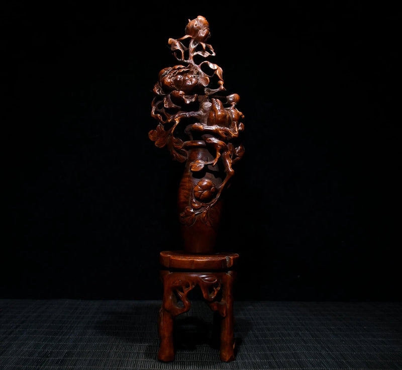 Carved peony flower and leaf branch wooden sculpture with pedestal, dark brown