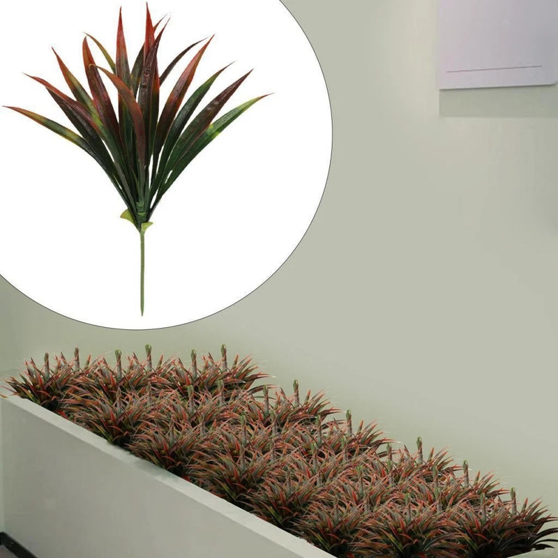 Faux grass plant shrub with long green blades and reddish-brown tips