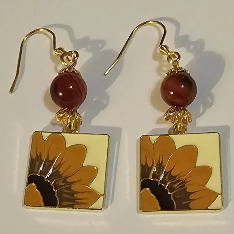 Gold-tone sunflower charm earrings with brown bead drops and square enamel panels
