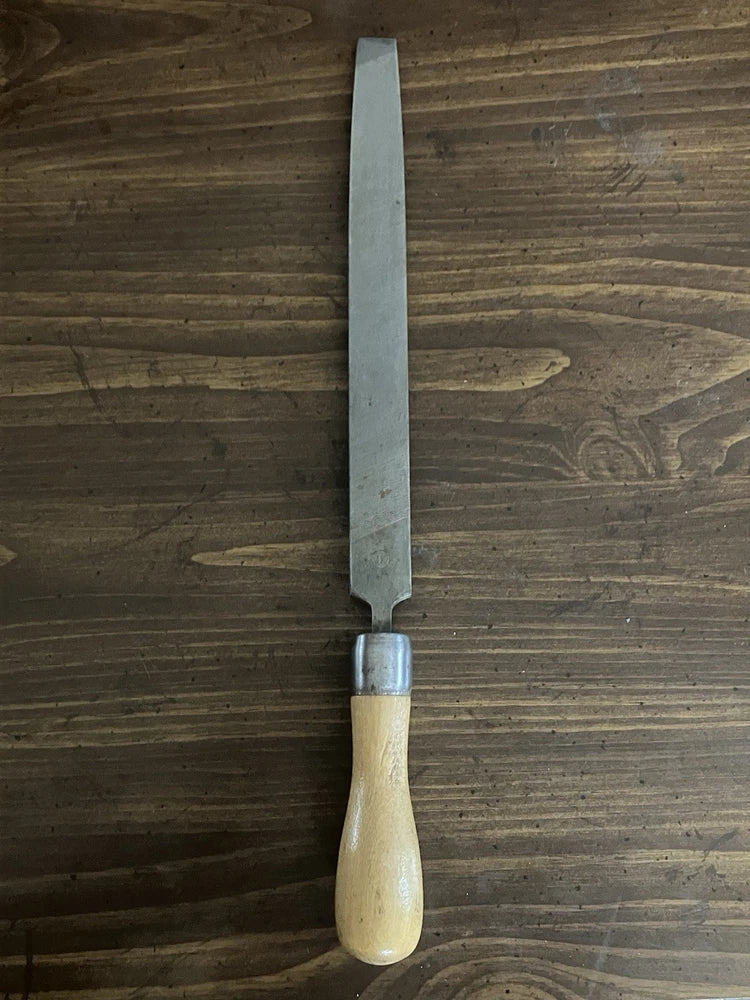 Carving knife with narrow metal blade and light wood handle