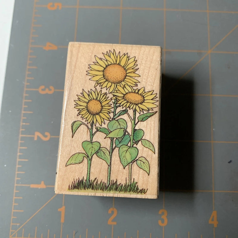 Wood rubber stamp with three sunflower flowers and green leaves