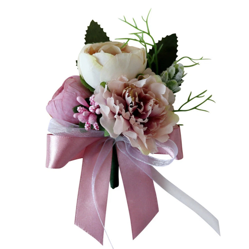 Artificial rose wedding boutonniere with pink and white blooms, greenery, and satin ribbon