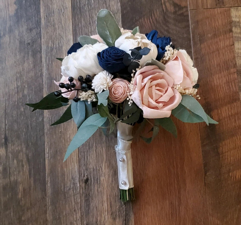 Artificial bridal bouquet with pink blush and navy blue flowers, greenery, and white accents
