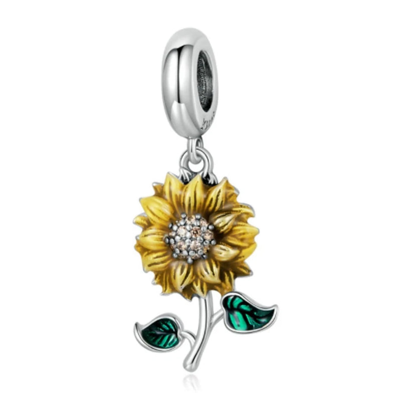 Sterling silver sunflower charm with jeweled center and green leaf accents