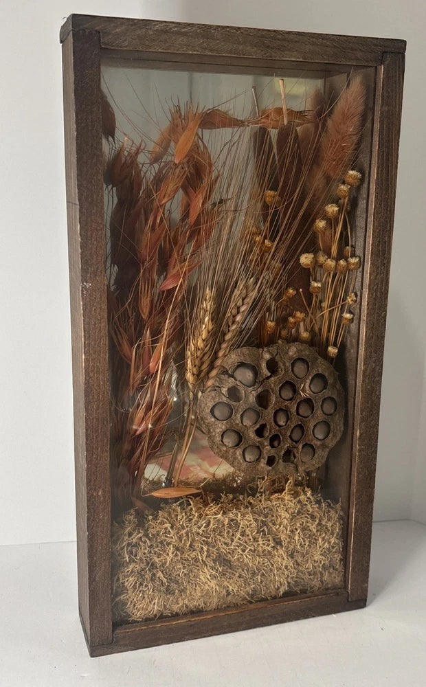 Wood-framed shadow box mirror with dried lotus pod and grasses, honeycomb centerpiece
