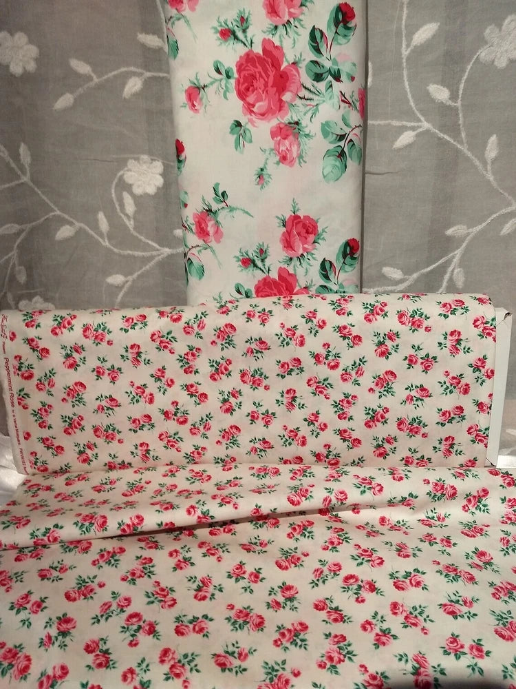 Cotton quilting fabric with pink rose floral pattern, folded