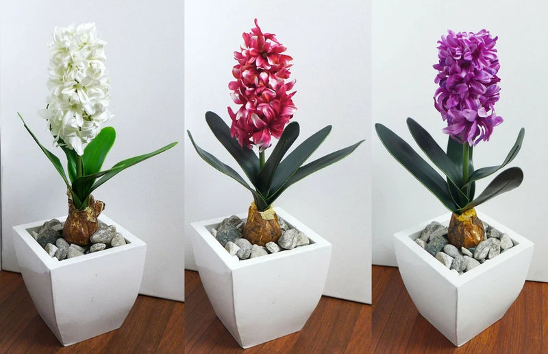 Artificial hyacinth flower arrangement in white square planter, white blossoms and green leaves