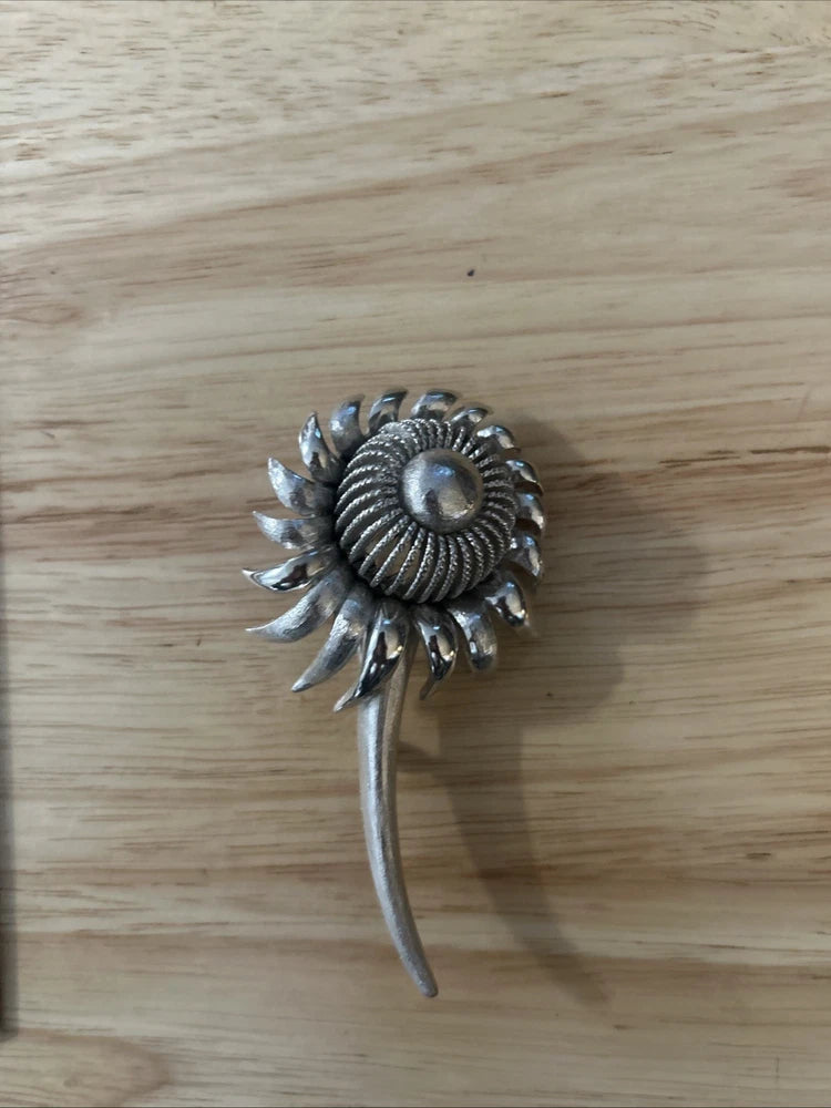 Coro sunflower brooch with brushed silver-tone textured petals, round center and pin stem