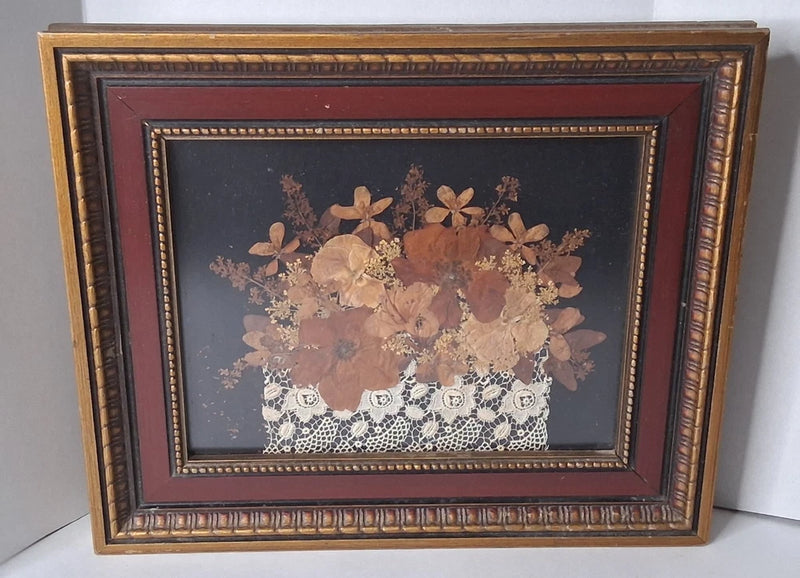 Gold and burgundy framed shadow box floral art with dried flowers and lace in dark backing