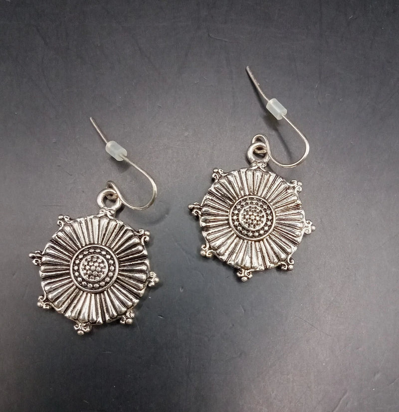 Silver-tone sunflower dangle earrings with pierced hooks and circular crystal center