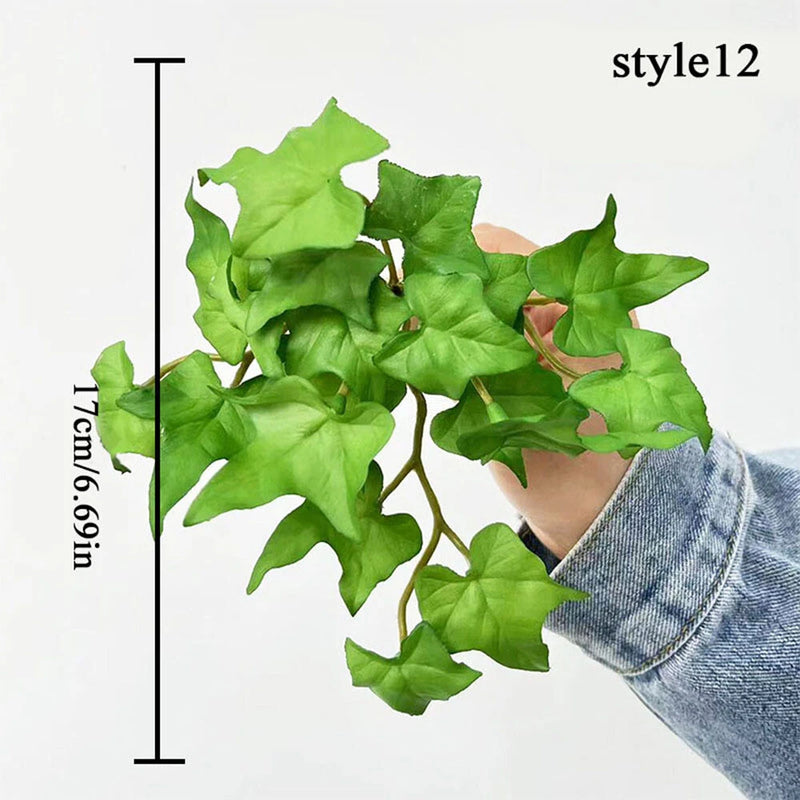 Artificial money grass plant with soft-touch green leaves, held in a hand