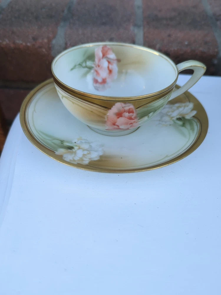 Porcelain tea cup and saucer with pink carnation floral and gold rim trim