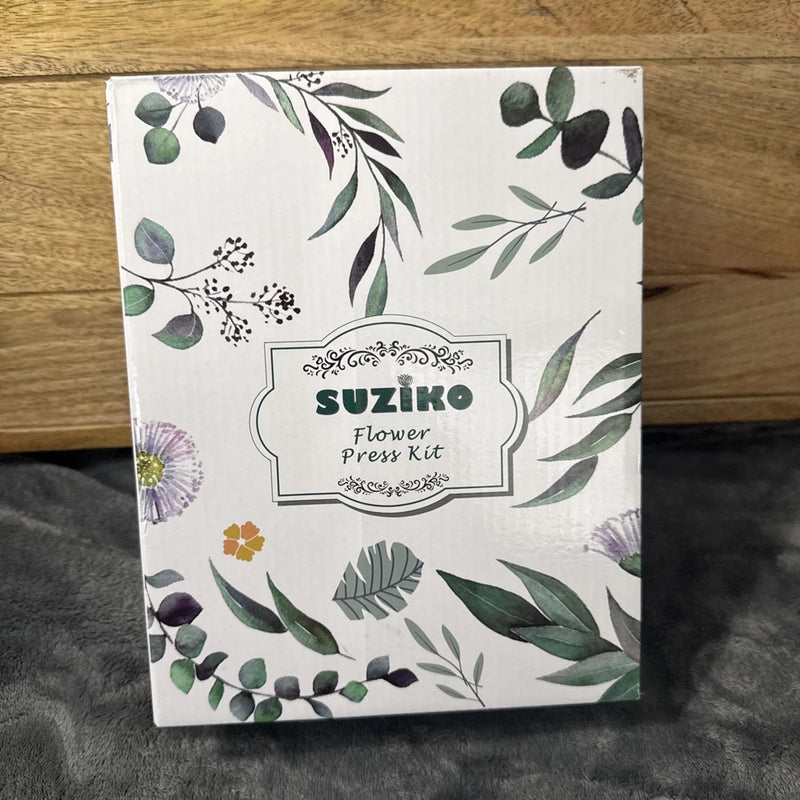 Flower press kit box with Suziko logo and botanical leaf floral print