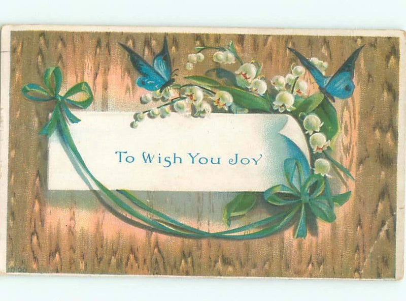 Decorative floral sign with blue butterflies, lily of the valley, and banner text 'To Wish You Joy'