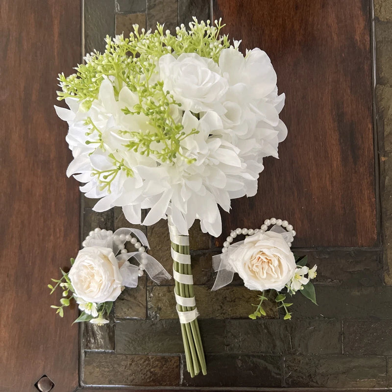 Sola flower bridal bouquet set with white blossoms, green accents, and pearl corsages