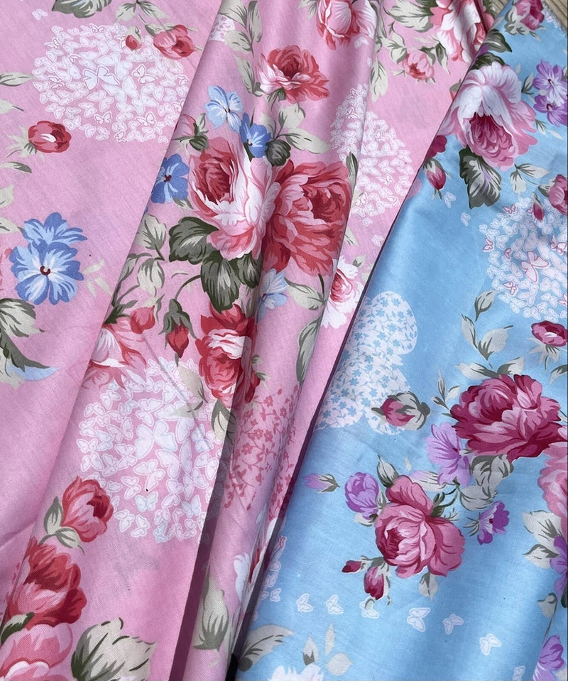 Pastel floral cotton fabric, pink and blue rose prints, folded yardage pieces