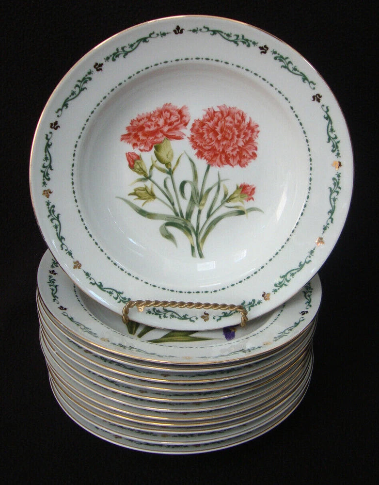 Rimmed soup bowl with red carnation bouquet and green decorative rim