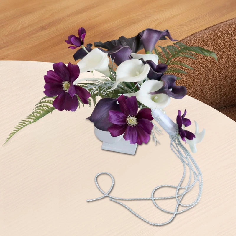 Artificial calla lily bouquet with white and dark purple blooms, green leaves, blue wire strands