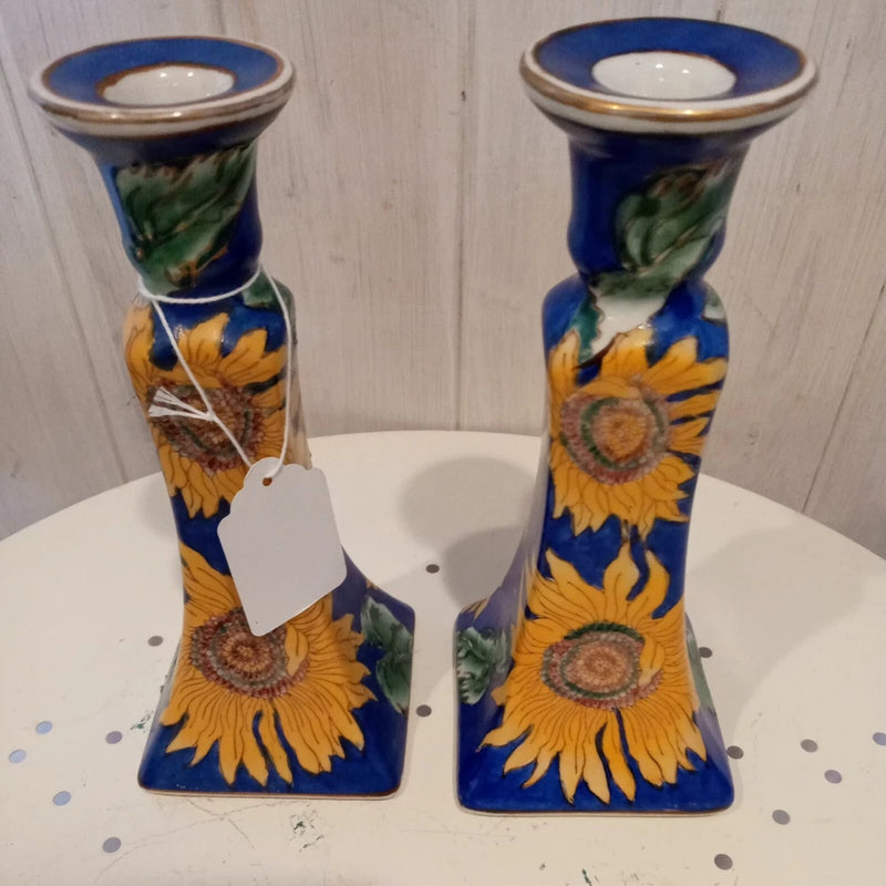 Pair of blue ceramic sunflower candle holders with yellow and green floral designs