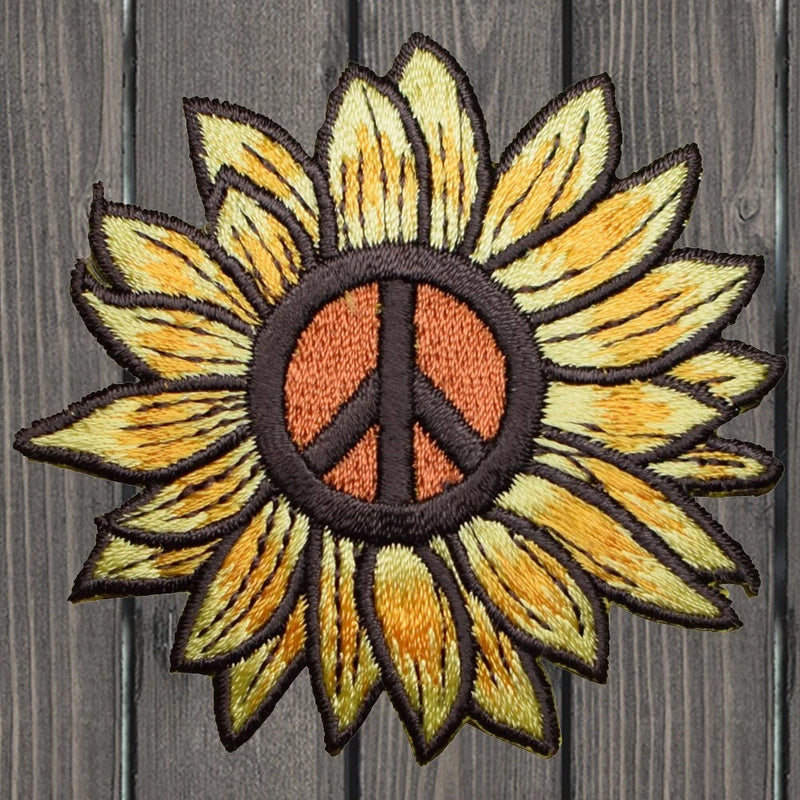 Embroidered sunflower peace-sign iron-on patch with yellow petals and peace symbol center
