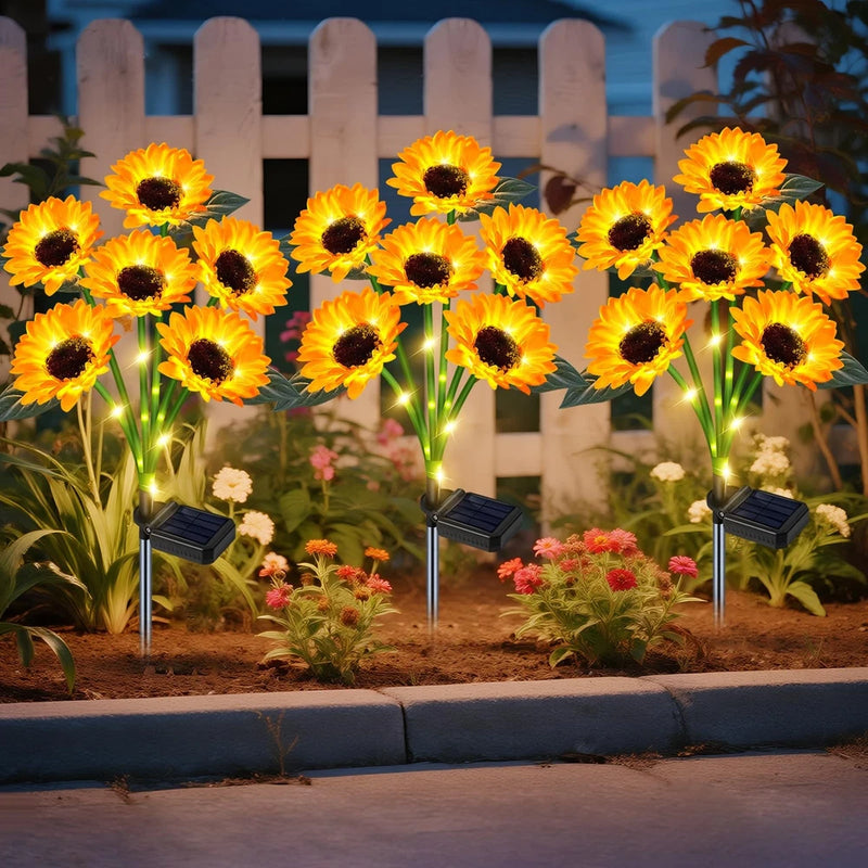 Solar sunflower garden lights, three-pack with black solar stakes and glowing flower heads