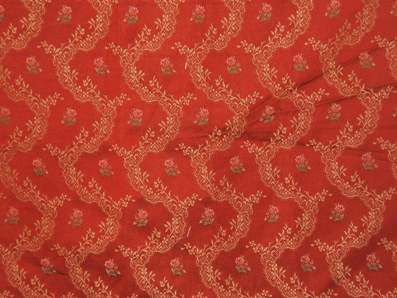 Red embroidered brocade remnant with small gold rose and vine pattern