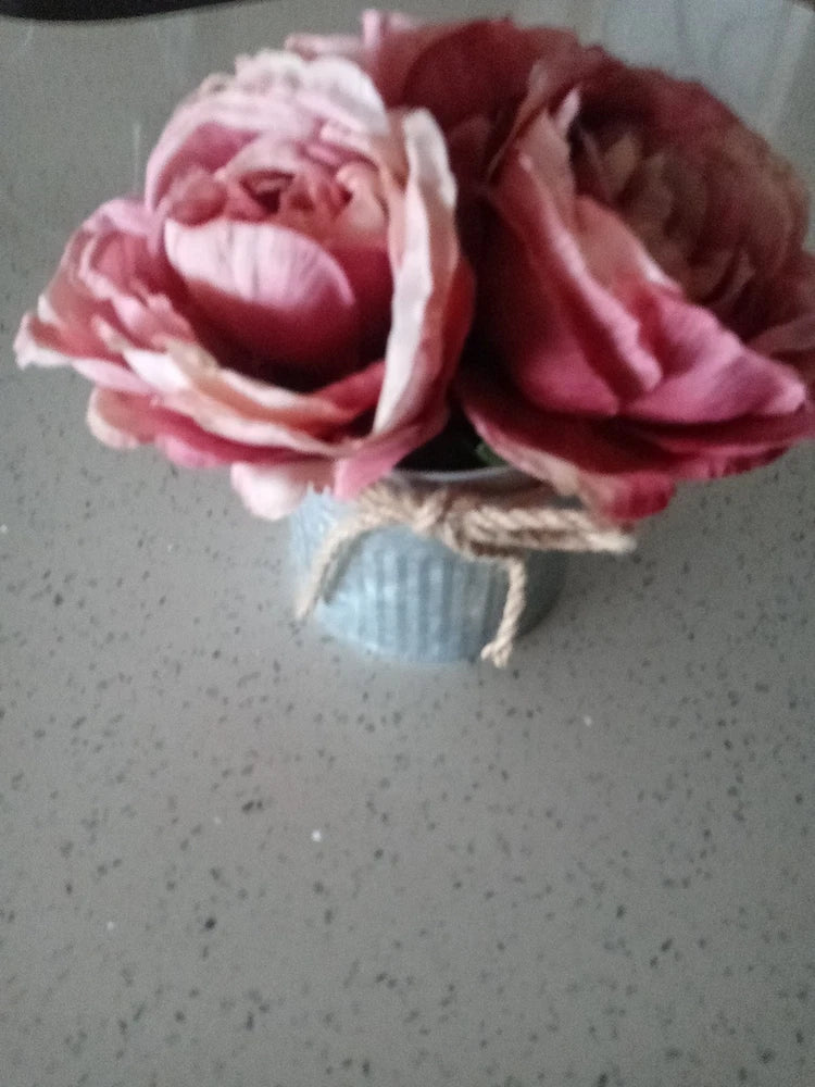 Pink and burgundy faux peony bouquet in galvanized steel pot, flowers close-up