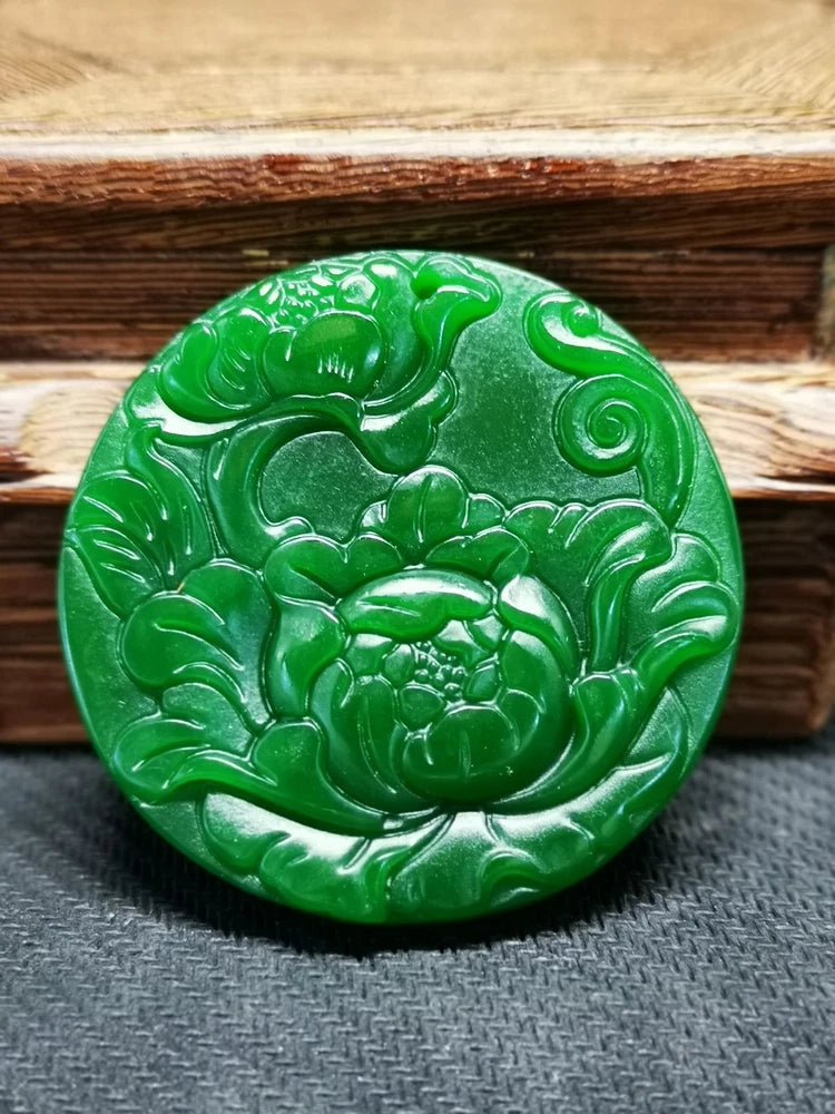 Green jade peony pendant, round disc with hand-carved floral relief.
