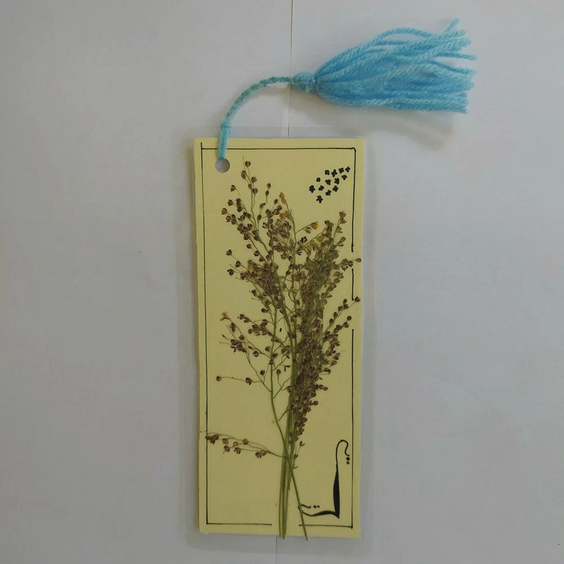 Pressed dried flower bookmark with blue tassel and botanical stem design