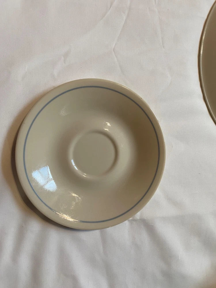 Ceramic saucer with blue border ring and central well