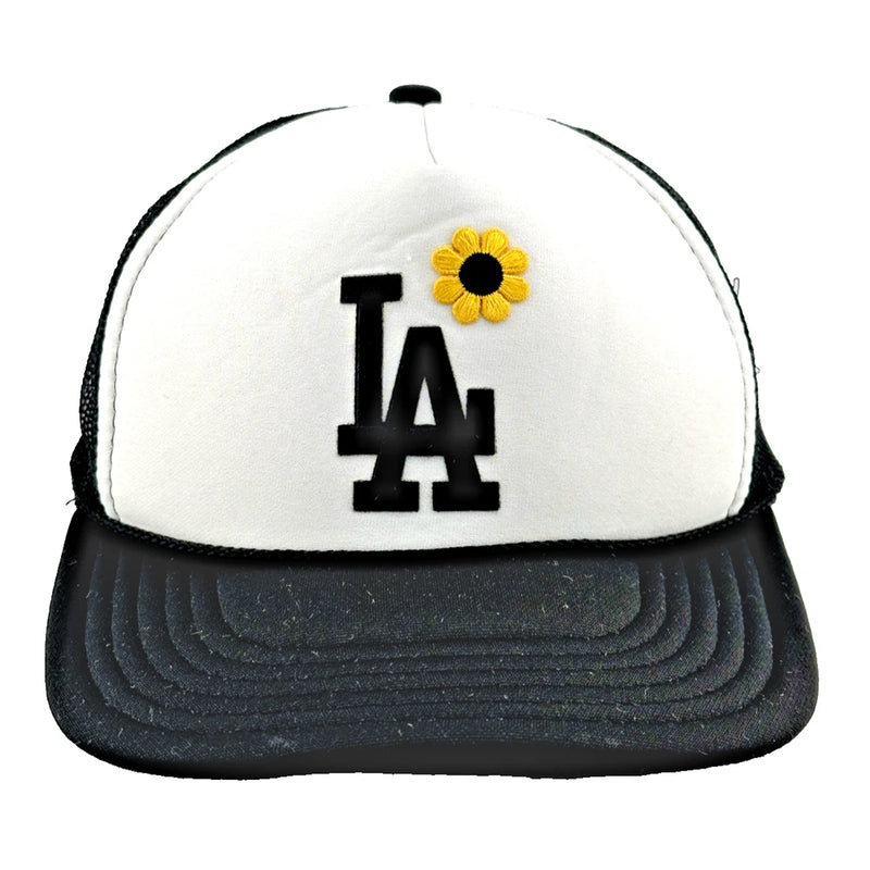 Adult baseball cap with white front, black brim, LA logo and yellow sunflower patch