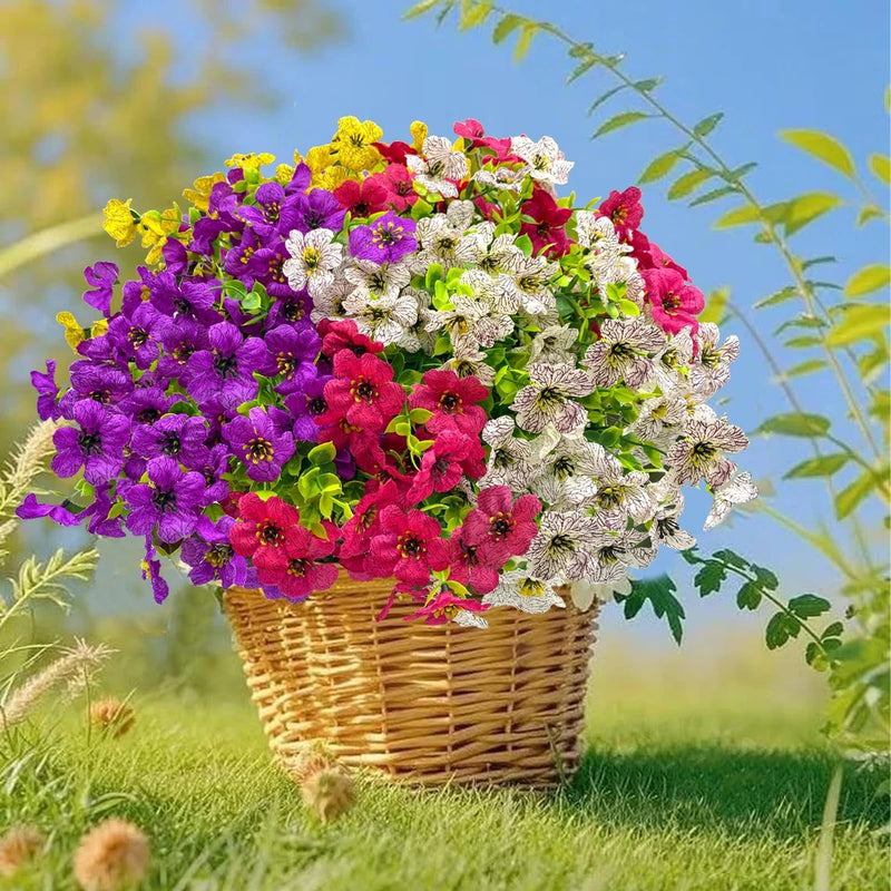 Artificial flower bundle in wicker basket with purple, pink, and white blooms