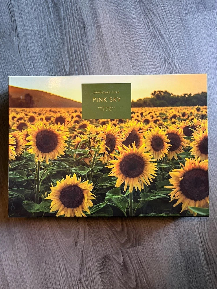Sunflower field 1000-piece jigsaw puzzle box with yellow sunflowers and pink sky