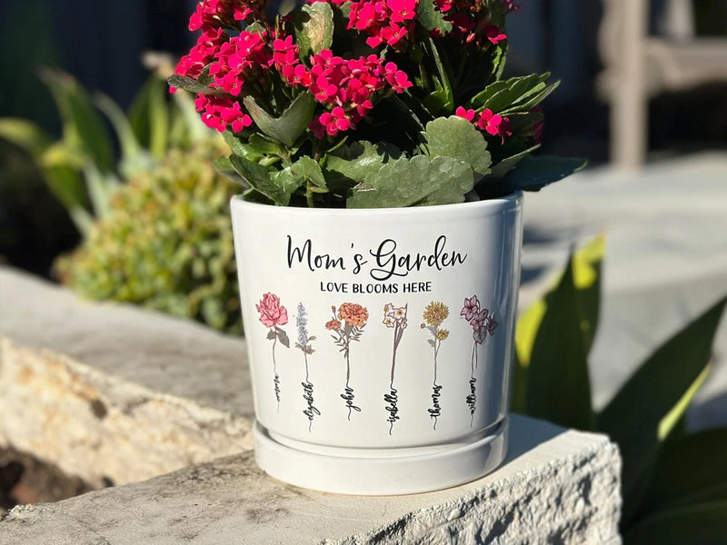 Personalized white plant pot with floral print and text "Mom's Garden".