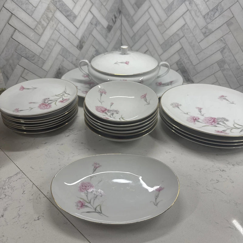 Fine china dinnerware set with floral carnation pattern, stacked plates and covered serving dish