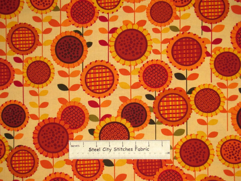 Cotton fabric yard with repeating sunflower and leaf pattern, warm orange and yellow