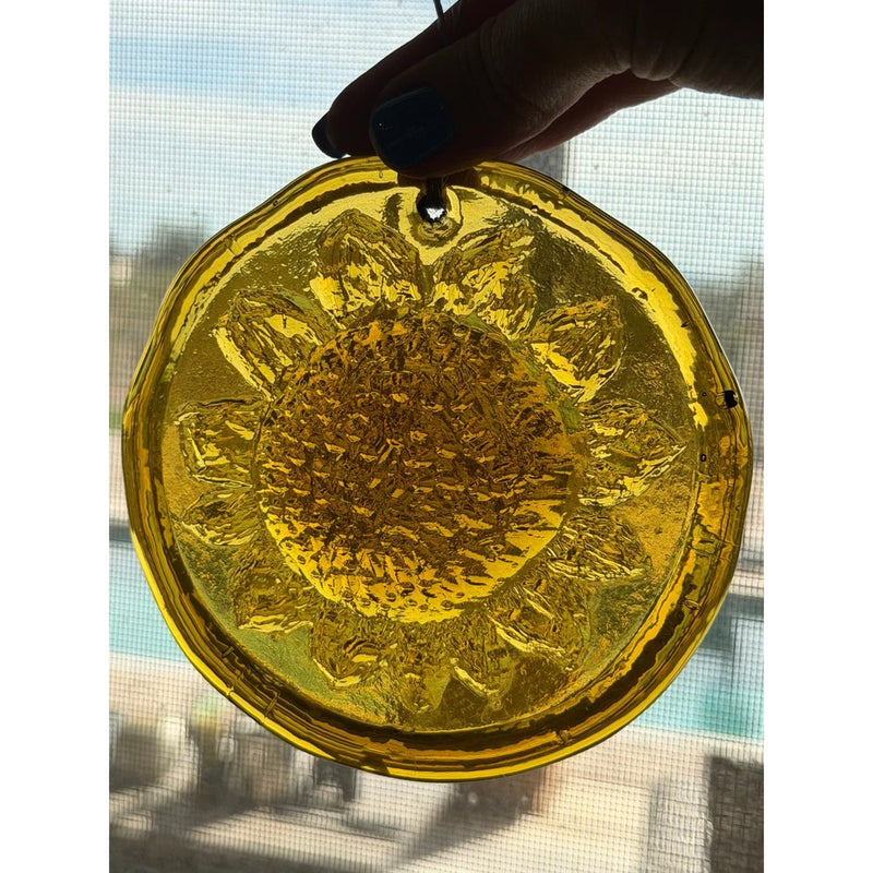 Round amber art glass sun catcher with sunflower relief design
