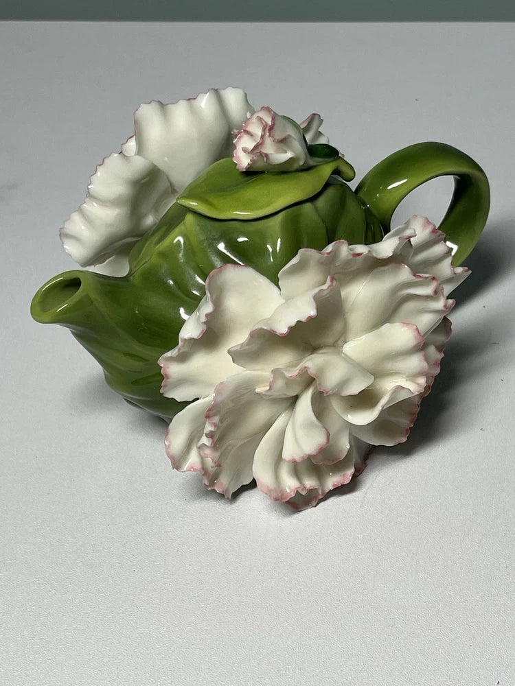 Green porcelain teapot with 3D white and pink carnation flower details and handle