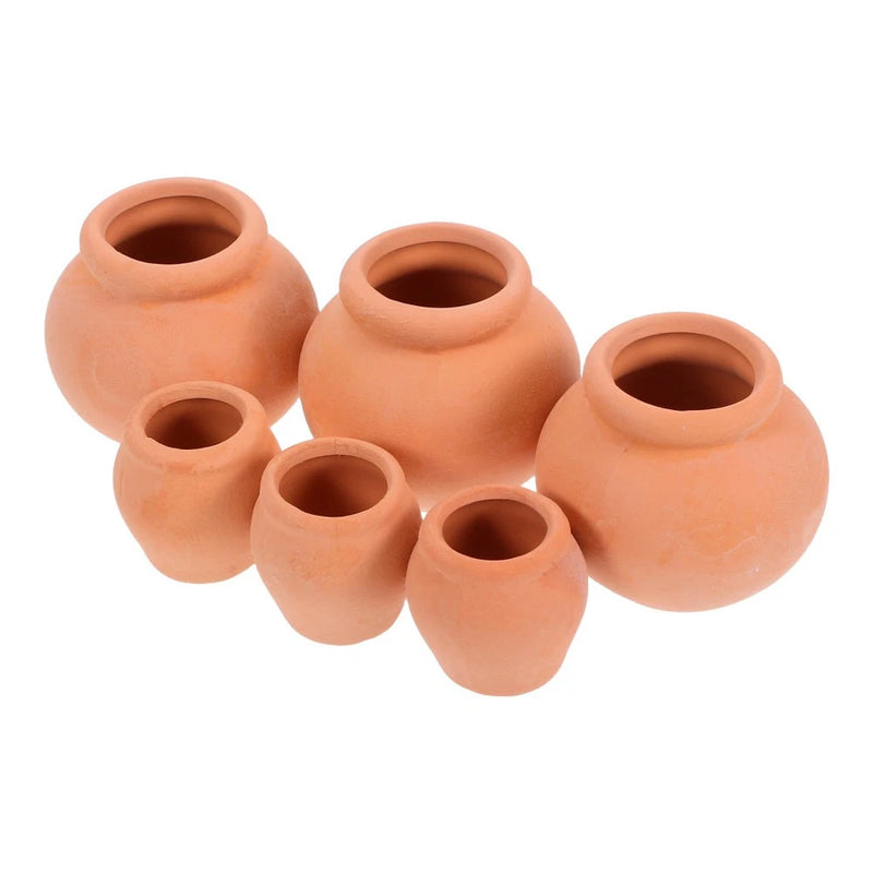 Set of 3 small terracotta clay plant pots in warm terracotta color, round shape