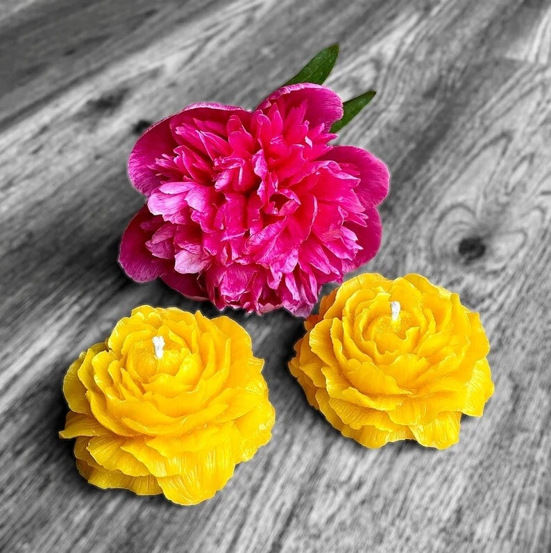 Peony flower candles, one pink and two yellow flower-shaped candles