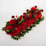 Red silk peony and rose floral arch backdrop with green leaves